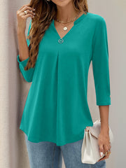 Teal V-neck three-quarter sleeve top with front pleats and button detail on sleeve cuff.