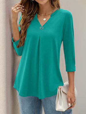 Teal V-neck three-quarter sleeve top with front pleats and button detail on sleeve cuff.