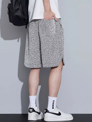 Men's boxer shorts in black and white abstract pattern with drawstring and side slits.