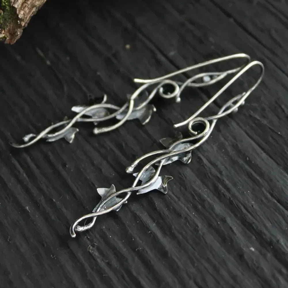 Silver ivy vine drop earrings with small gemstone accents.