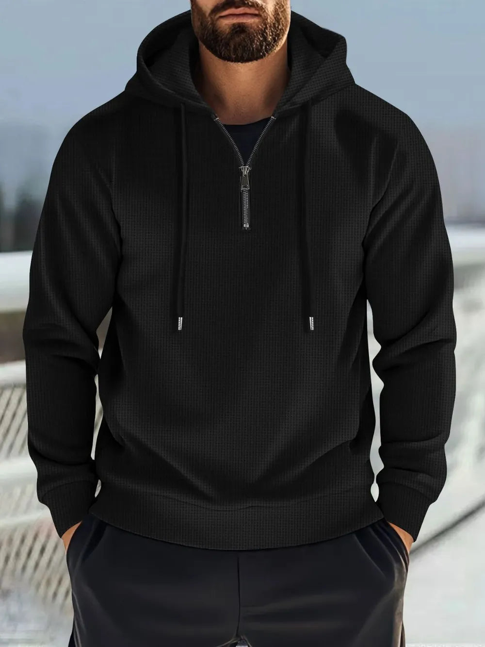 Black waffle-knit quarter-zip hooded pullover with drawstring.