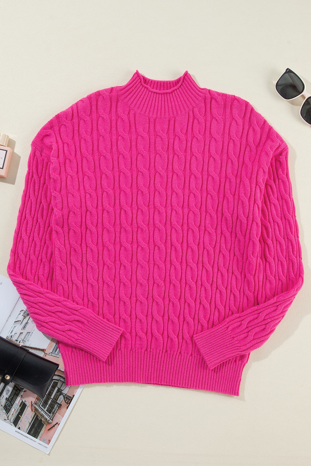 Hot pink cable knit mock neck pullover sweater with ribbed cuffs and hem.