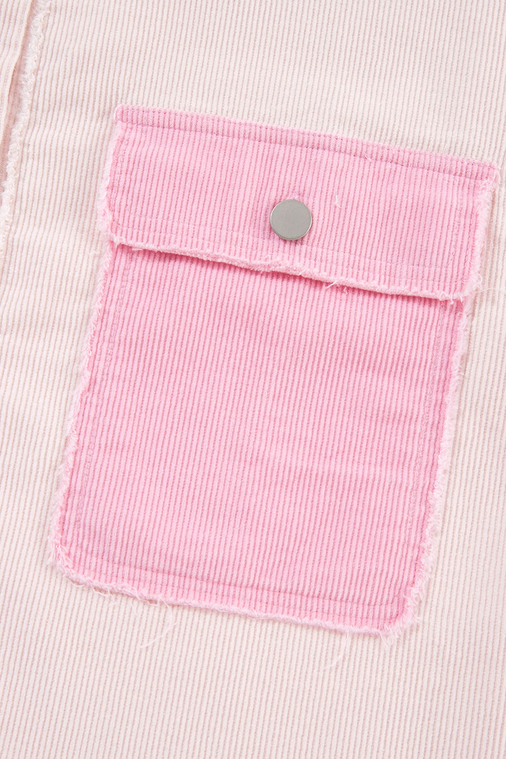 Colorblock corduroy shacket in blush pink with raw edge pocket detail.