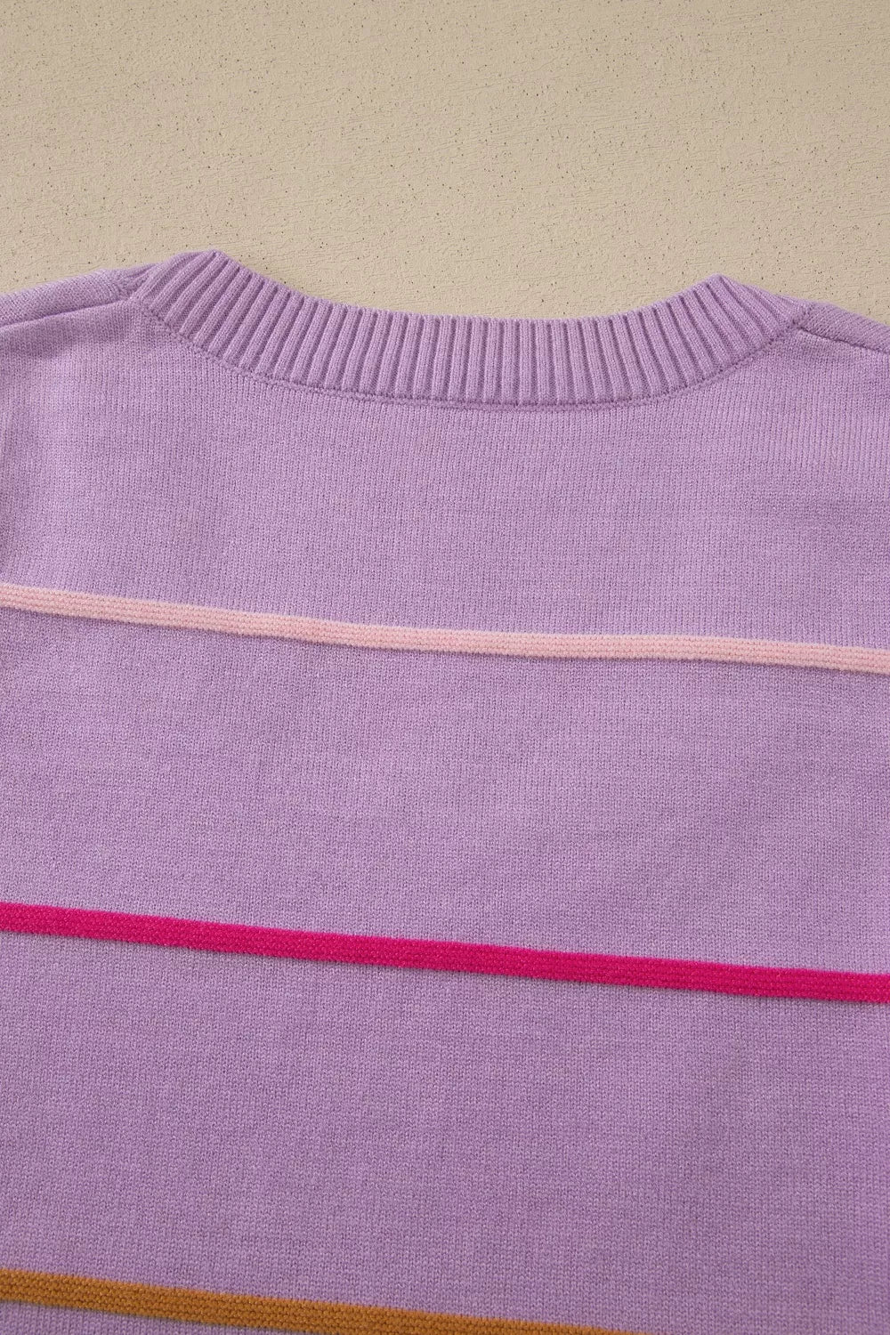 Lavender knit sweater vest with horizontal pink and orange stripes.