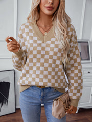 Checkerboard knit v-neck pullover sweater in camel and white, with long sleeves and a relaxed fit.