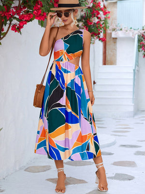 Abstract cutout midi dress with one-shoulder design and bold geometric print.
