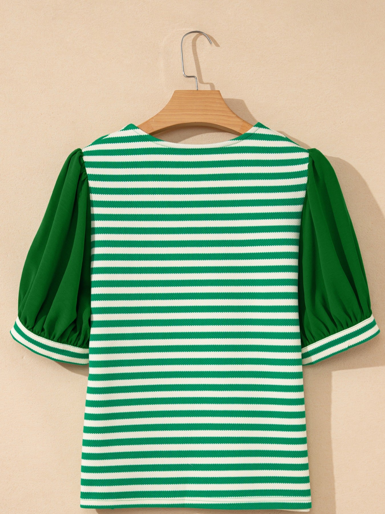 Green and white striped sweater with puff sleeves and V-neck.