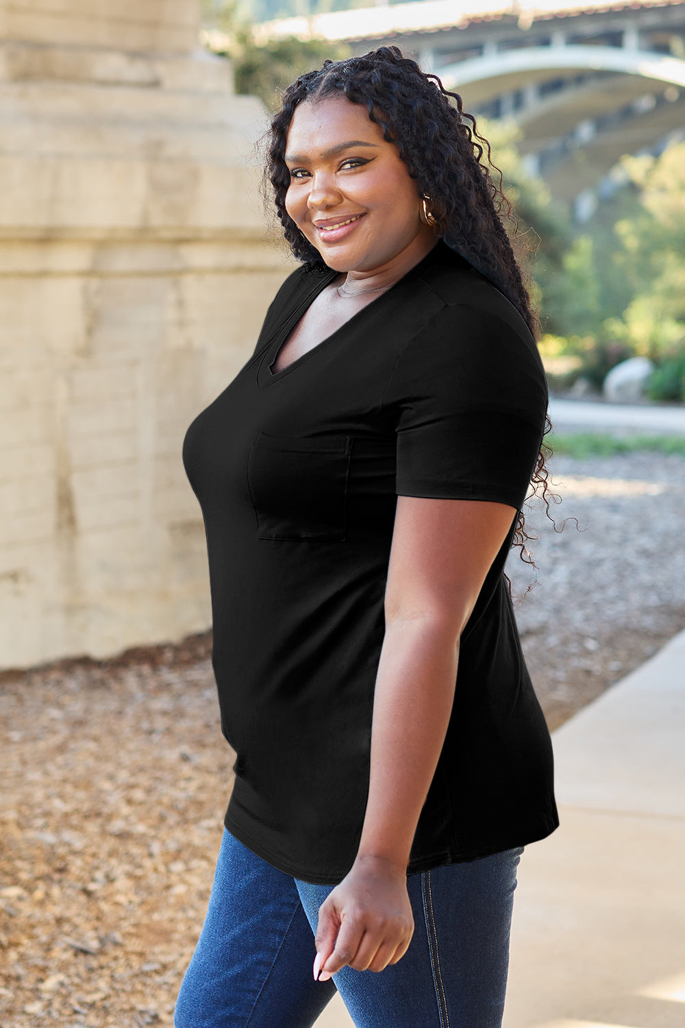 Black V-neck pocket tee with short sleeves and a relaxed fit.