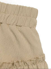 Tiered ruffle mini skirt in tan with elastic waistband and textured fabric.