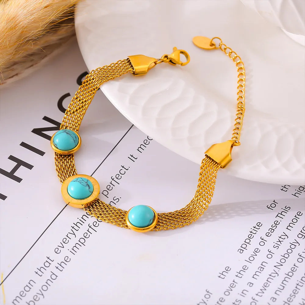 Gold mesh bracelet with turquoise stones and Roman numerals
