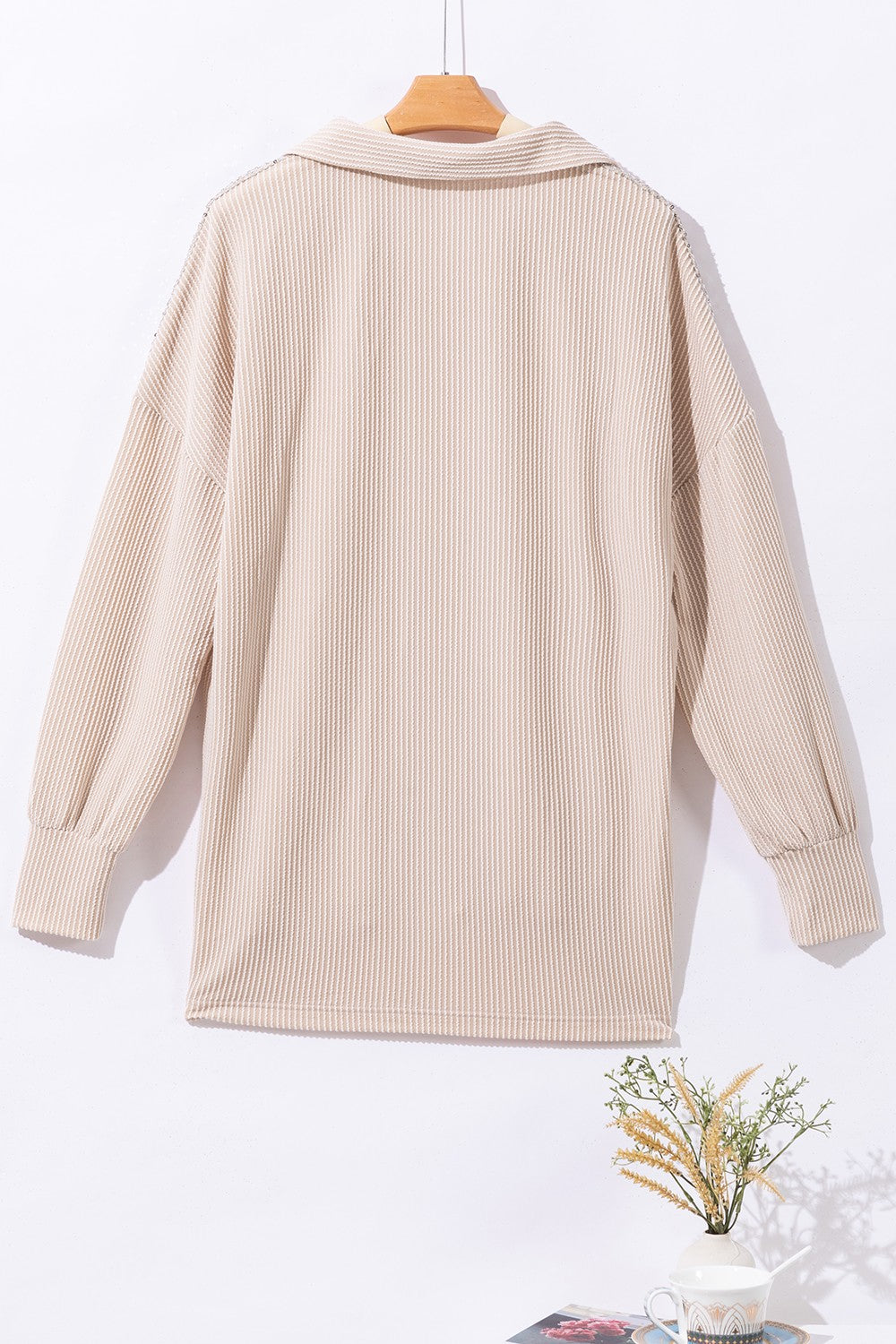 Tan textured knit shirt jacket with collar and buttoned front, long sleeves.