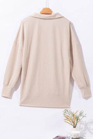 Tan textured knit shirt jacket with collar and buttoned front, long sleeves.