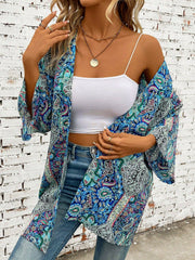 Teal paisley print kimono sleeve duster with wide sleeves and open front, styled with a white cami and jeans.