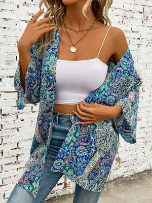 Teal paisley print kimono sleeve duster with wide sleeves and open front, styled with a white cami and jeans.