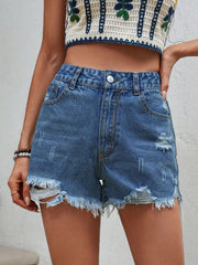 Distressed denim shorts in medium wash with frayed hem and ripped details.