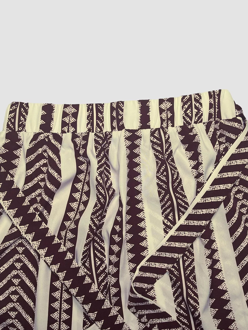 Geometric print maternity pants in black and white with a tie bow detail.