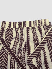 Geometric print maternity pants in black and white with a tie bow detail.