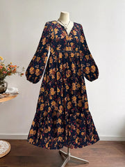 Maxi dress with floral print, V-neck, balloon sleeves, and tiered hem.