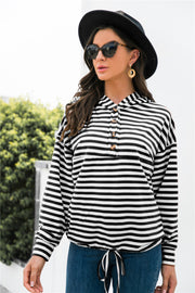 Black and white striped hoodie with button neck detail and drawstring waist.