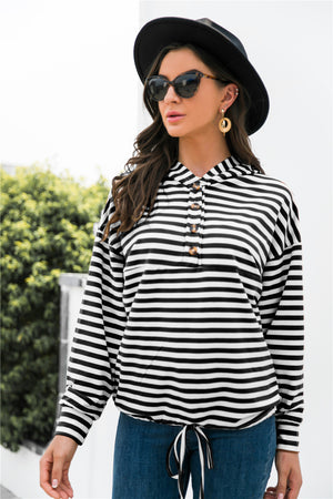 Black and white striped hoodie with button neck detail and drawstring waist.