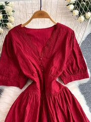 Crimson lace-embellished A-line midi dress with V-neck and button detail.