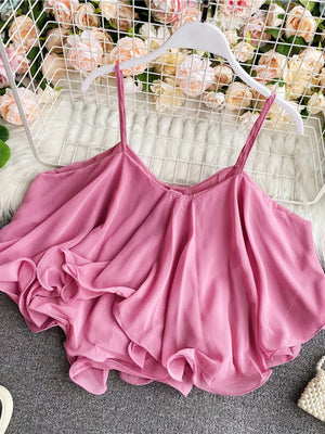 Pink camisole with spaghetti straps and ruffled hem detail