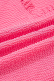 Women's pink textured embroidered blouse with a subtle diamond pattern.