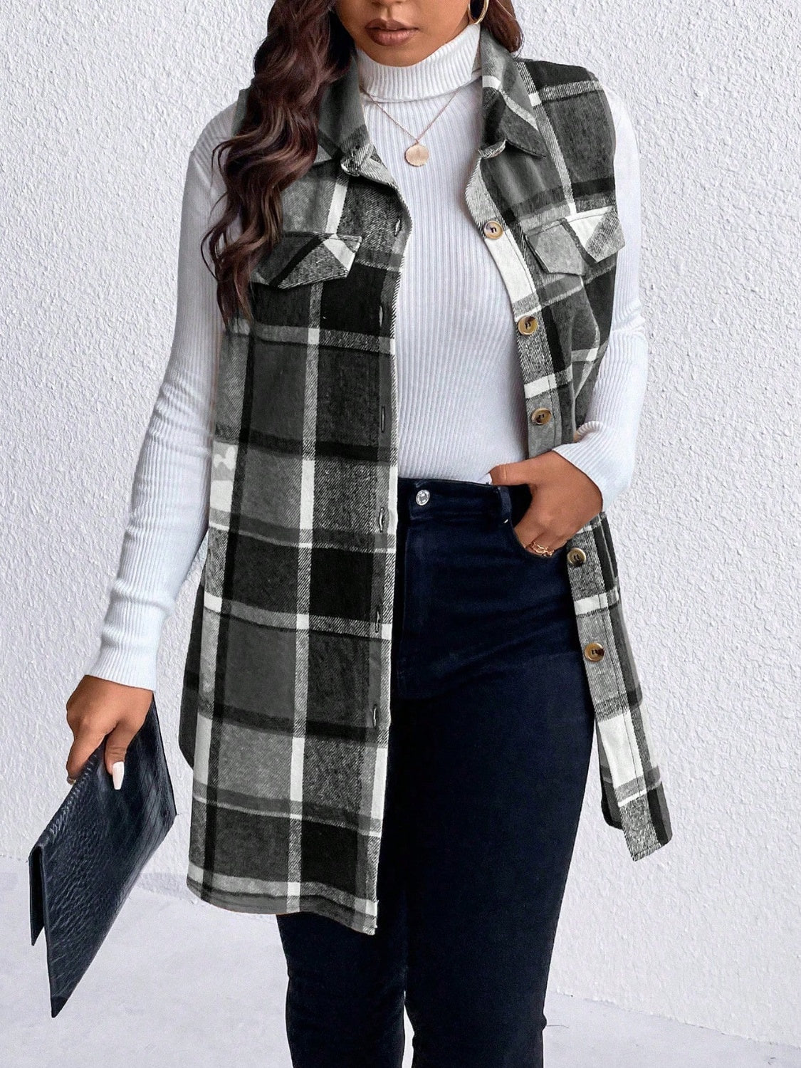 Oversized plaid shirt vest in black and white with button front and chest pockets.