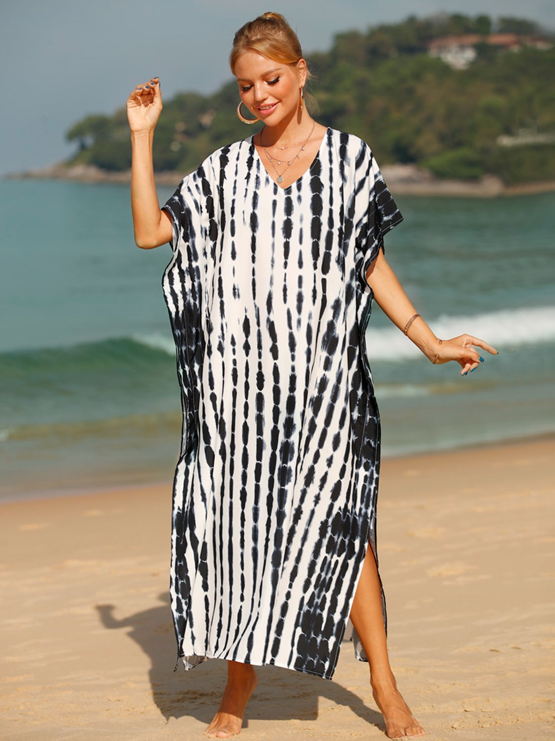 Black tie-dye maxi kaftan with vertical stripes, V-neck, short sleeves, and side slits.
