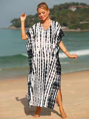 Black tie-dye maxi kaftan with vertical stripes, V-neck, short sleeves, and side slits.