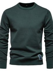 Essential crew neck knit sweater in Black Forest green with ribbed cuffs and hem.