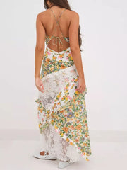 Floral lace maxi dress with ruffles and a tie-back detail.