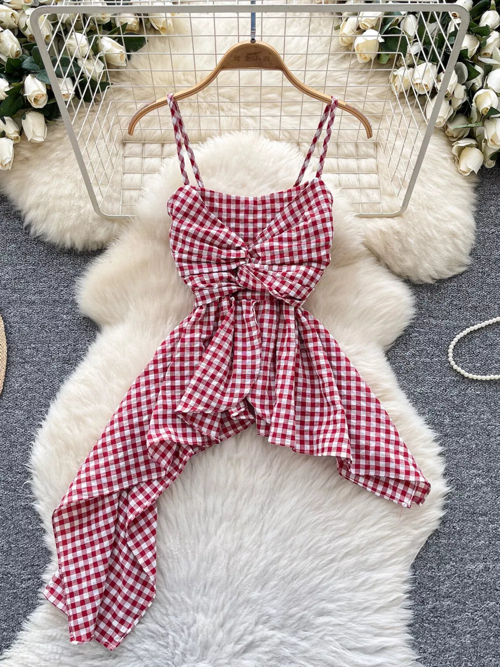 Red gingham asymmetrical cami top with twisted knot detail and spaghetti straps.