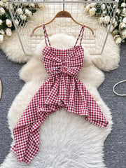 Red gingham asymmetrical cami top with twisted knot detail and spaghetti straps.