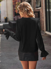 Black polyester blouse with ruffled shoulders and bell sleeves.