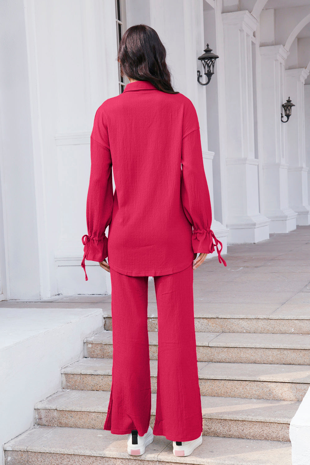Textured tie-sleeve co-ord set in hot pink with wide-leg pants and split hems.