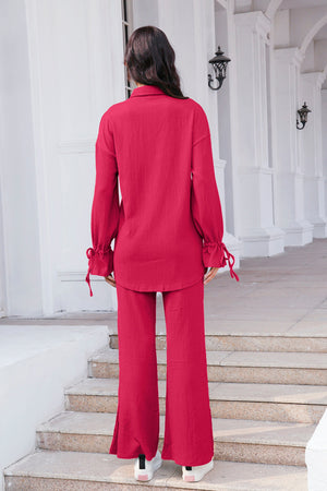 Textured tie-sleeve co-ord set in hot pink with wide-leg pants and split hems.