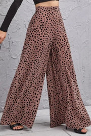 Spotted wide-leg palazzo trousers in dusty pink with a high waist and flowing silhouette.