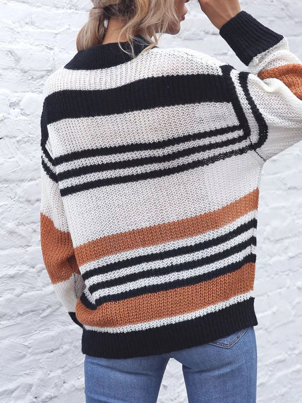 Casual striped knit sweater with color block accents in beige, black, and white acrylic.