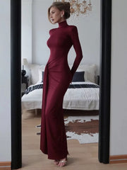 Burgundy turtleneck maxi dress with long sleeves and draped tie detail.