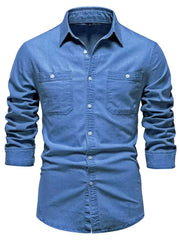 Light blue faded denim utility shirt with two chest pockets and button-down closure.
