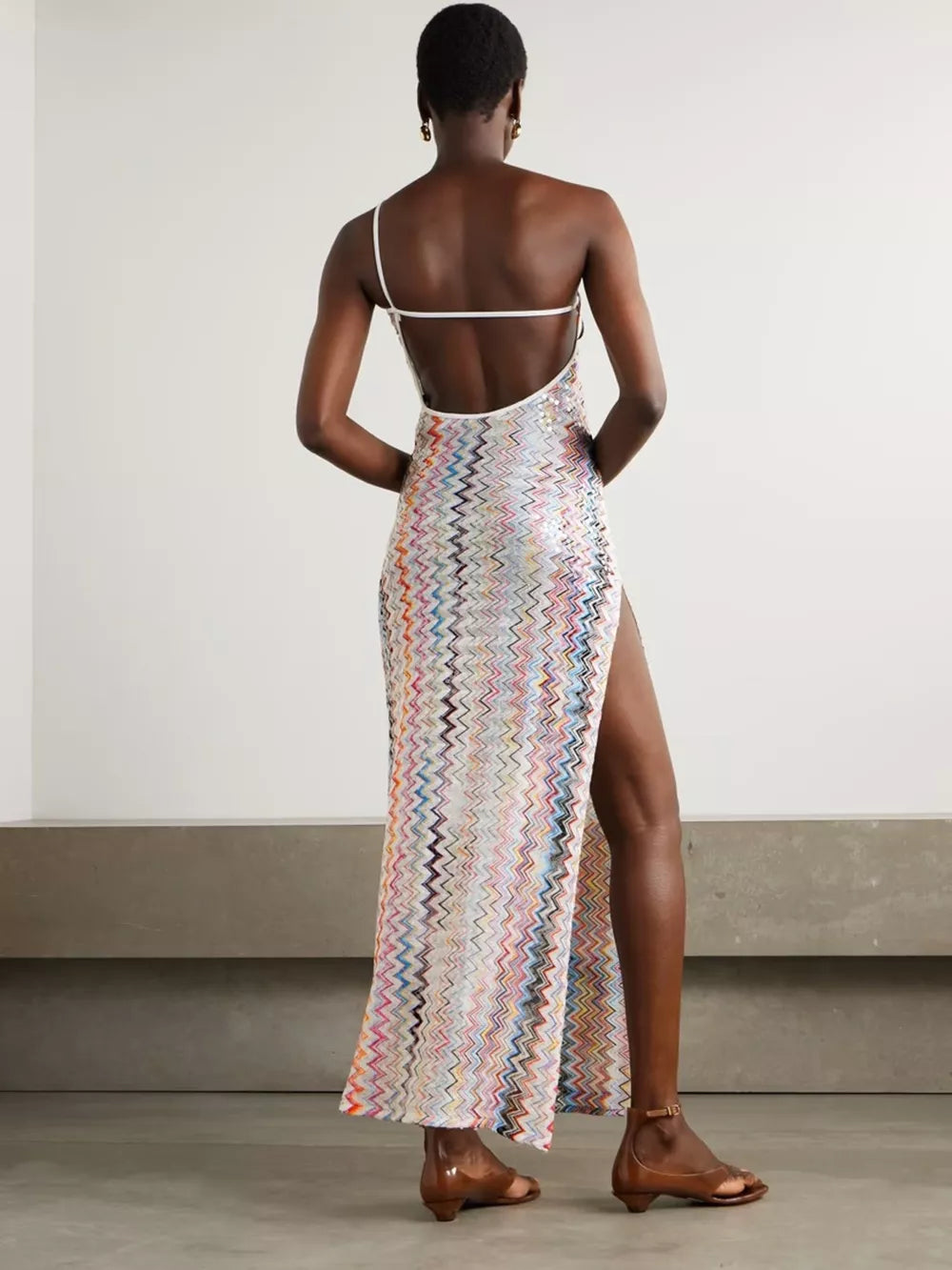 Zigzag one-shoulder maxi dress with a high slit and open back.
