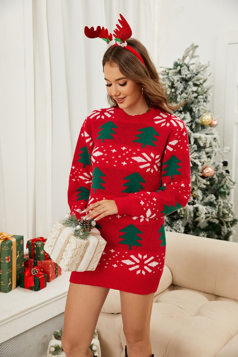 Red acrylic mini sweater dress with green Christmas trees and white snowflakes, crew neck, long sleeves.