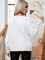 White acrylic cable knit raglan sleeve pullover sweater with ribbed cuffs and hem.
