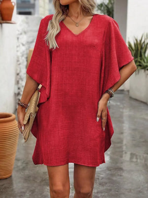 Red v-neck mini dress with ruffled sleeves and a textured fabric.