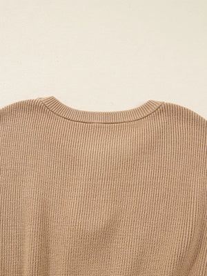 Ribbed knit sweater dress in tan with a crew neck and keyhole detail.