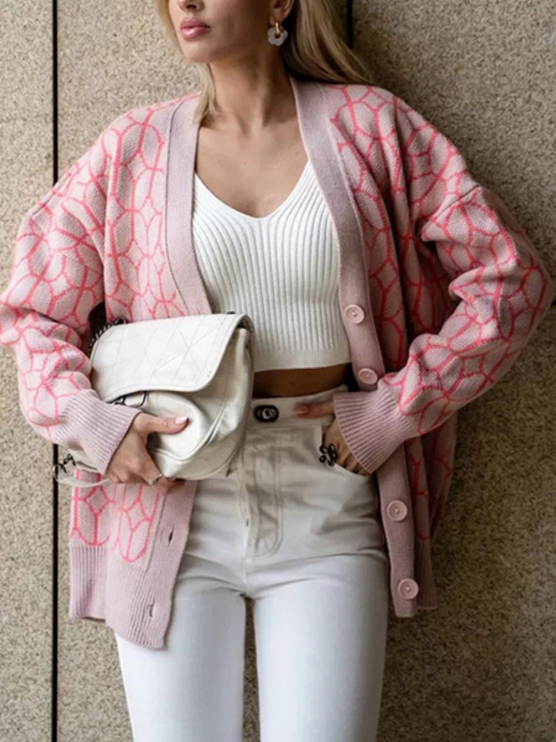 Dusty pink geometric knit button-up cardigan with pink accents, acrylic, v-neck, long sleeves.