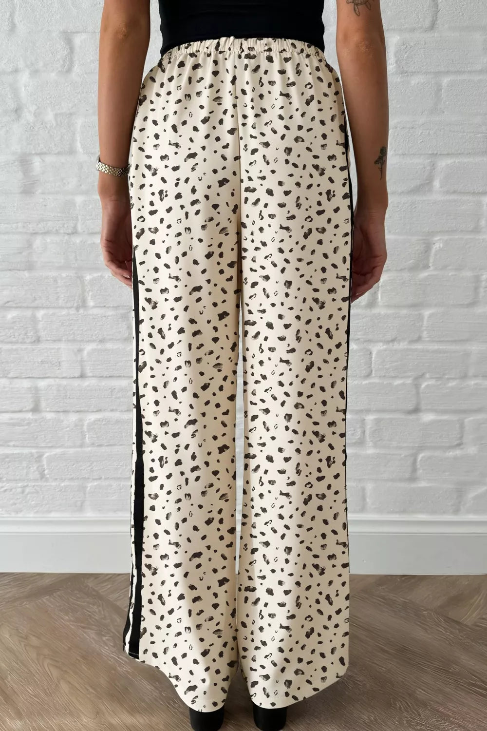 Maternity leggings with cream leopard print and black side stripes.
