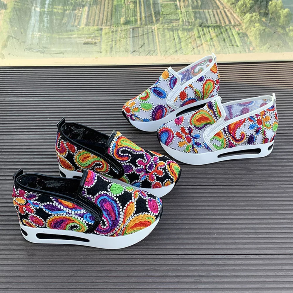 Paisley print platform slip-on shoes in white and black with chunky soles.