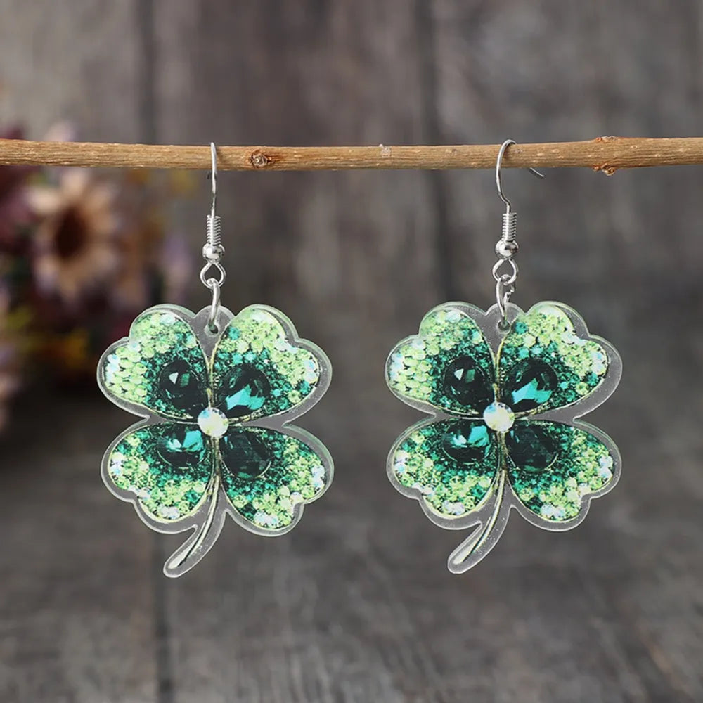 Dark green acrylic clover earrings with gemstone accents.